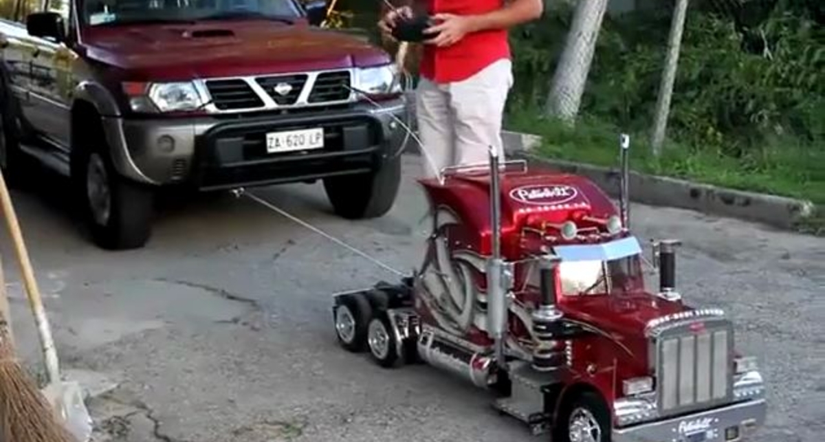 Игрушечный грузовик отбуксировал внедорожник
